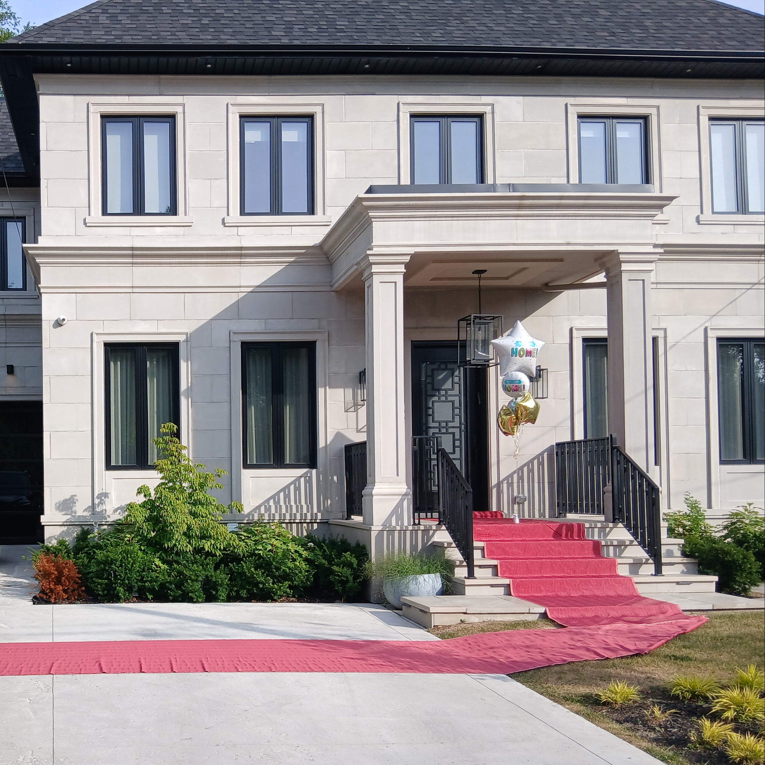 Luxurious house with a red carpet leading up to the entrance